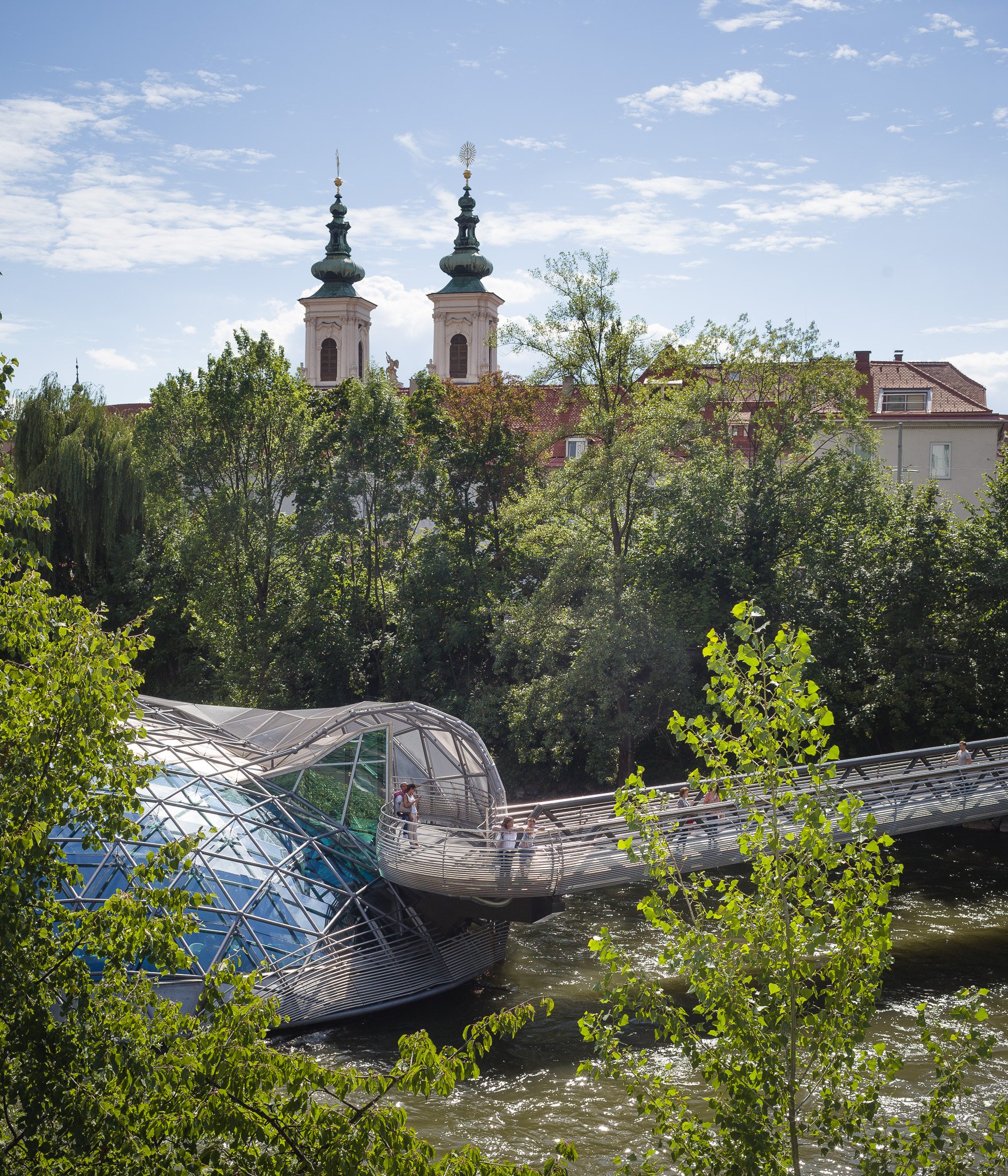 Modern architecture (Murinsel) and church romantics, the Mur has a lot of water.